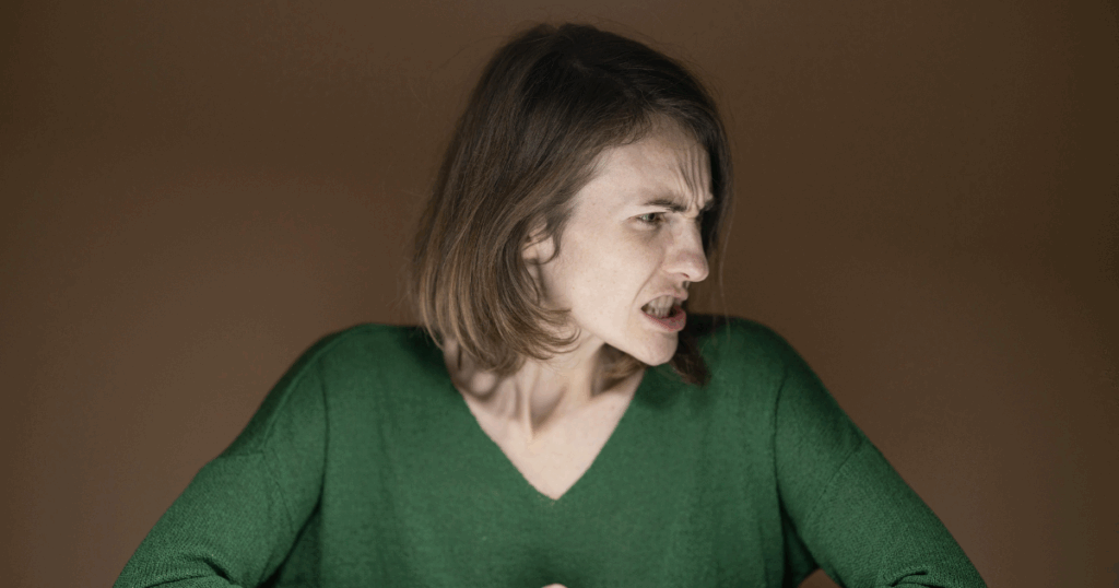 Woman experiencing Sertraline withdrawal symptoms, displaying anger and frustration. Managing medication withdrawal with strategies.
