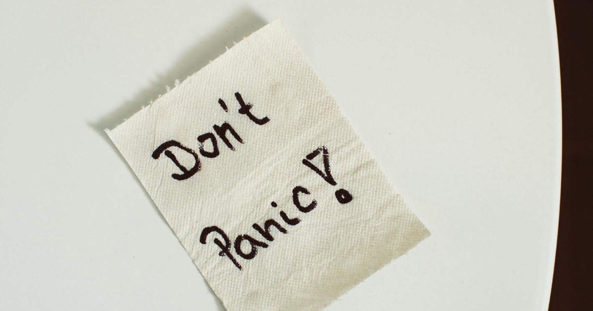 Don't Panic! Handwritten note on napkin, a reminder for effective panic attack management techniques and staying calm.